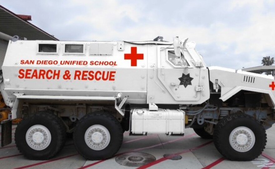 A rendering of the San Diego Unified School District's new MRAP shows it in white, with red ambulance markings. When district police received it, the vehicle was military tan.