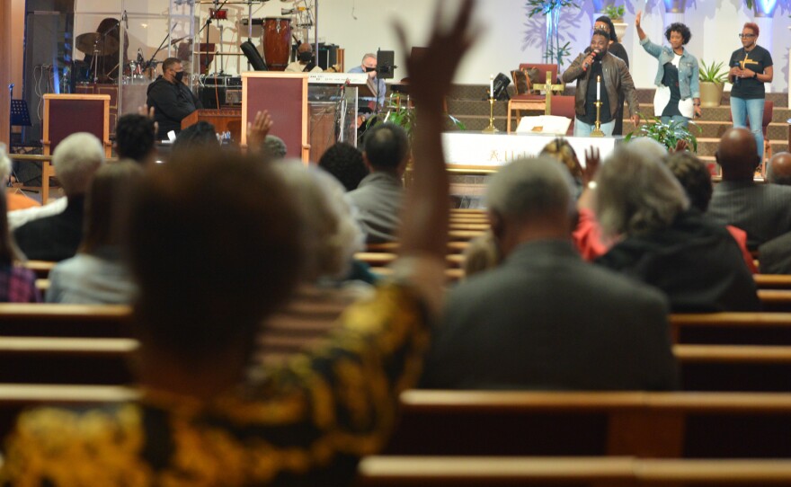 A quartet takes the place of a choir at a physically distanced service at St. James United Methodist in Kansas City.