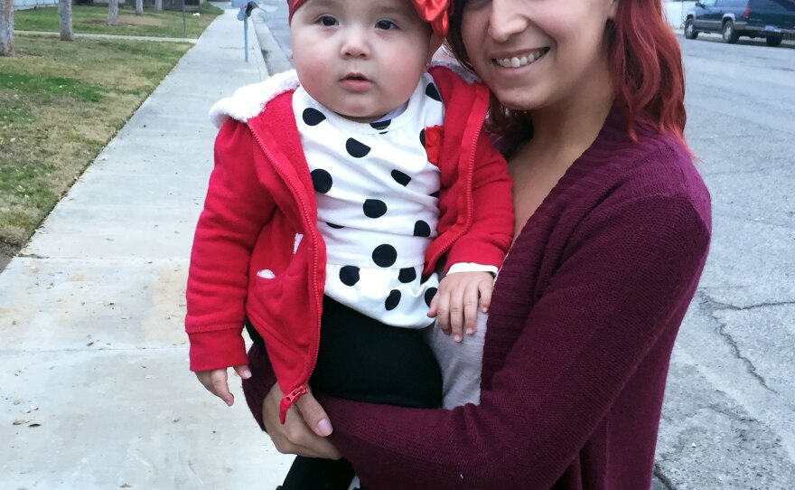 Cassandra Baca, 22, and her daughter, Amoriee. Baca says she's too busy as a working single mom to think about voting.