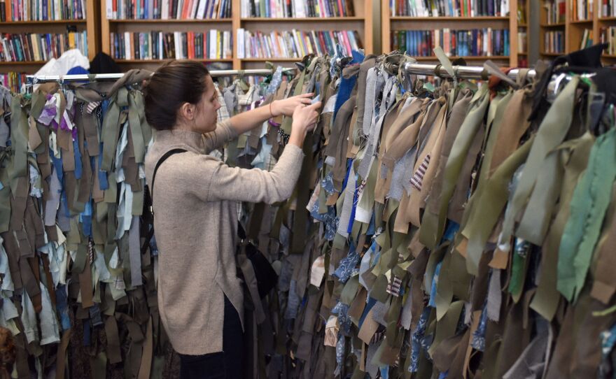 A volunteer makes camouflage nets for the Ukrainian military at a library in Lviv, in western Ukraine.