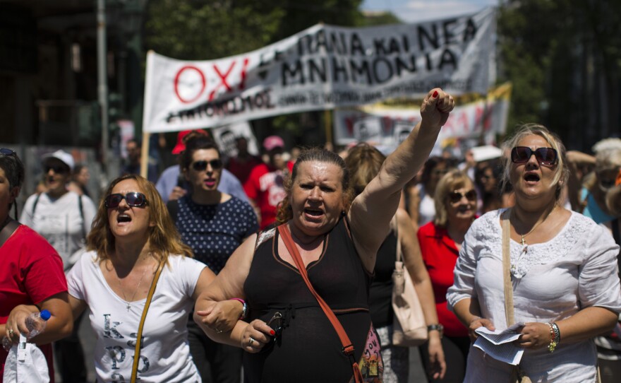 Anti-austerity demonstrators shout slogans during a protest in central Athens on Wednesday. Greek Prime Minister Alexis Tsipras faced a revolt in his left-wing party and workers' called for strikes ahead of a vote in Parliament.