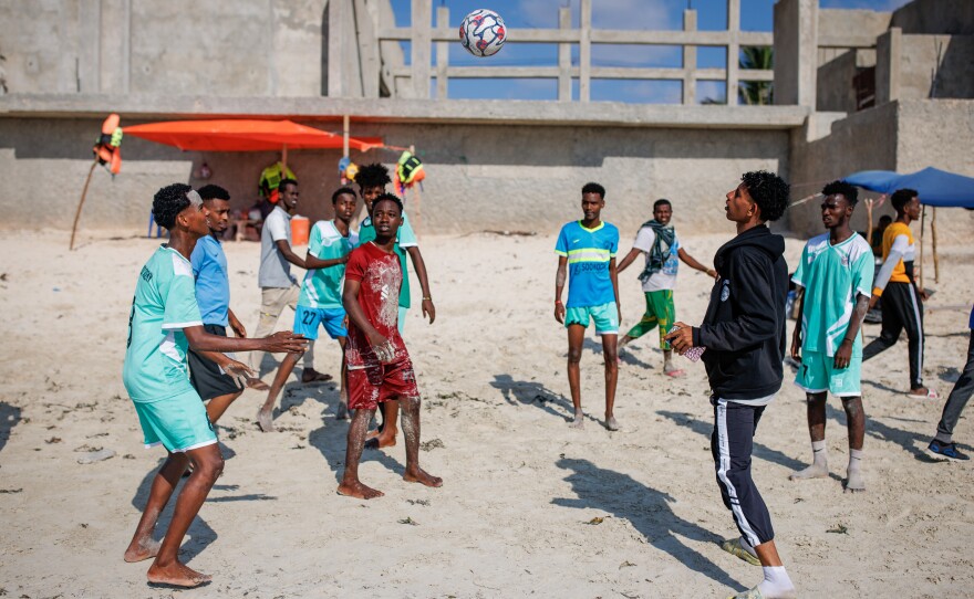 A group of young men kick around a soccer ball on the sand at Liido Beach in Mogadishu, Somalia. Residents of the Somali capital flock to the beach on Fridays, the first day of the weekend.