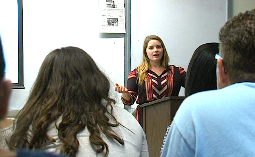 Campus coordinator Brittnie Bloom speaks to a Chicano studies class about Covered California on November 20, 2014.