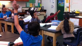 Mann Middle School seventh graders wait to be called on while working on projects for an upcoming science fair. 