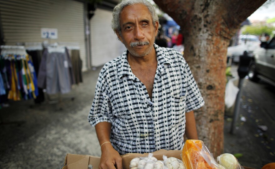 Miguel Sanchez sells fruits and vegetables on the street in Rio Piedras.