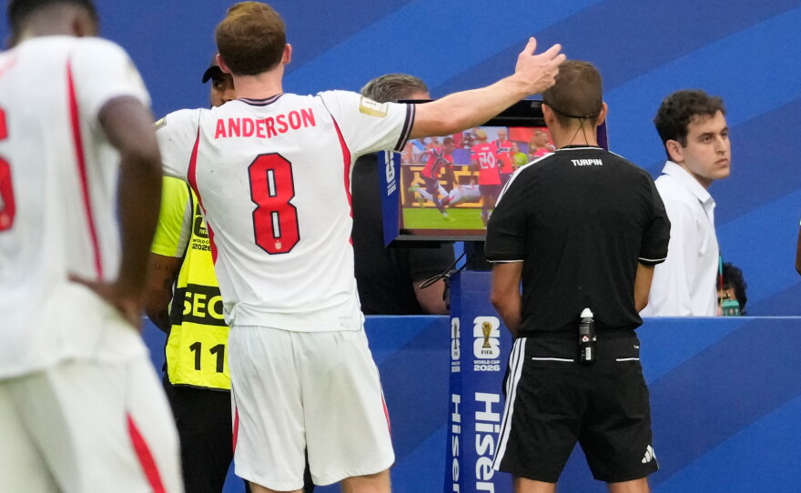 FIFA referee Clement Turpin watches a VAR replay screen to check for a possible penalty during the World Cup quarterfinal soccer match between Norway and England in Miami Gardens, Fla., Saturday, July 11.
