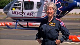 Kelly Forman, a Mercy Air flight nurse, stands in front of a helicopter in Oceanside, May 11, 2022.
