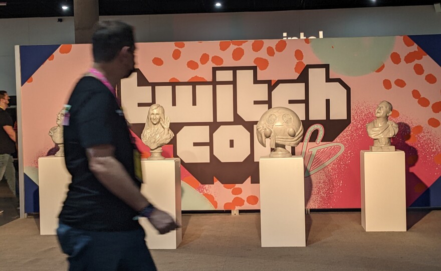 A man walking by a TwitchCon art display inside the San Diego Convention Center, Oct. 8, 2022.