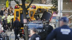 Authorities respond near a damaged school bus Tuesday, Oct. 31, 2017, in New York. 