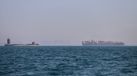 A container ship and a cargo vessel are seen in the Strait of Hormuz off Bandar Abbas, Iran, on June 17.
