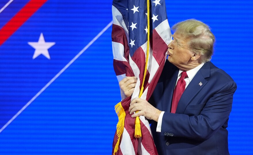 Before he was elected to a second term, former President Donald Trump hugged and kissed the U.S. flag as he spoke at the Conservative Political Action Conference at National Harbor, in Oxon Hill, Md., in 2024.