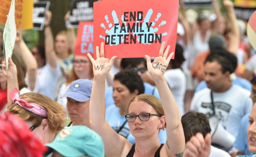 People demonstrate in Washington, D.C., on Thursday, demanding an end to the separation of migrant children from their parents. On Friday, the Justice Department said in a court filing that "the government will not separate families but detain families together during the pendency of immigration proceedings."
