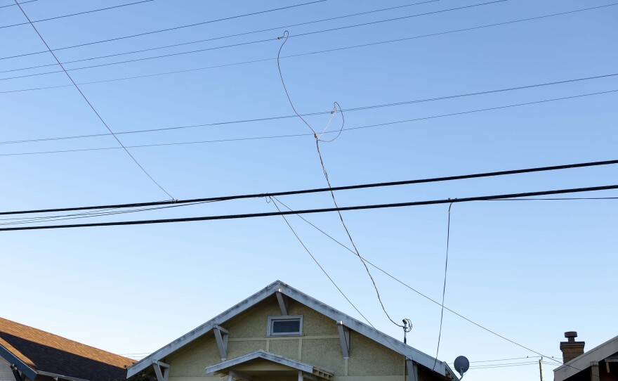 Powerlines are pictured over a home in North Oakland in this undated photo. 