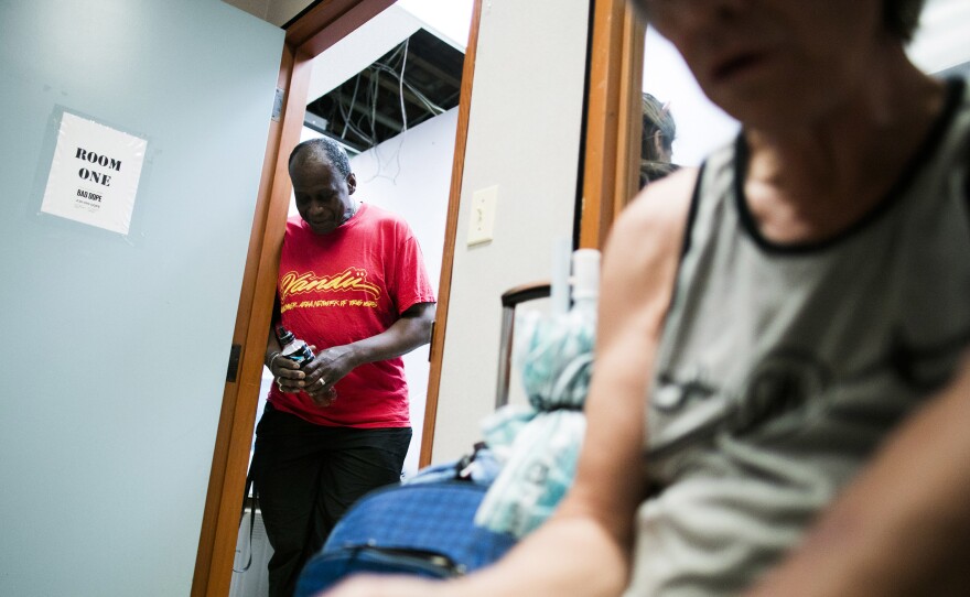 Hugh Lampkin, left, watches over the supervised injection room inside VANDU in Vancouver's Downtown Eastside, British Columbia.