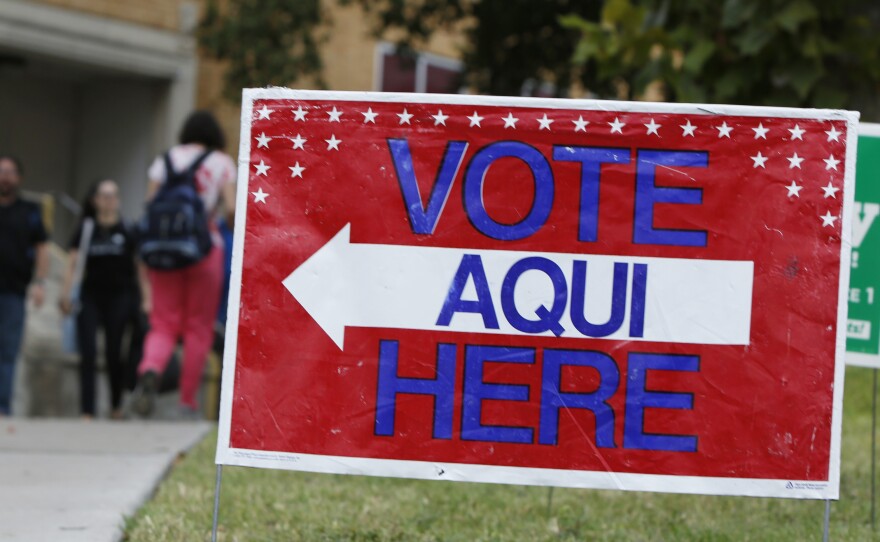 A sign shows the way to a polling station in Austin, Texas. A federal appeals court has knocked down a state voter ID law.