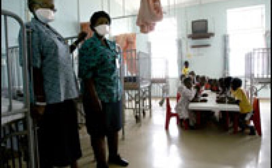 South African nurses wear masks in a pediatric TB ward's playroom at a hospital on the outskirts of Johannesburg.