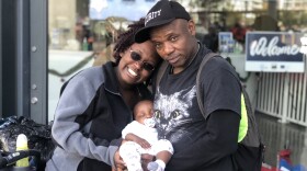 Marcus Rouse, his girlfriend Ka Mcmackins and their baby Keyelimn stand outside of the city's new homeless navigation center, Dec. 9, 2019.