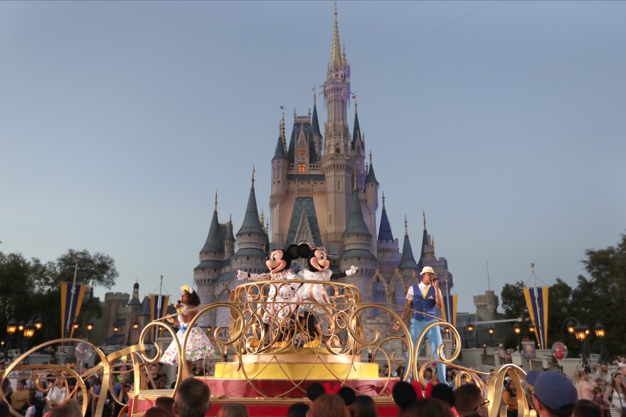 Mickey and Minnie Mouse perform in the undated photo during a parade as they pass by the Cinderella Castle at the Magic Kingdom theme park at Walt Disney World in Lake Buena Vista, Fla.