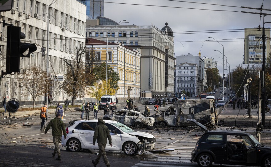 Emergency service personnel attend to the site of a blast on in Kyiv on Monday.