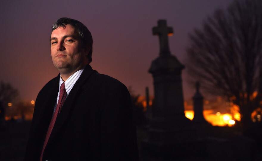 Brett Talley stands in Holy Rood Cemetery in Washington, D.C., in 2014. Talley had been rated "unanimously unqualified" for a lifetime judicial appointment and his nomination "will not be moving forward," according to a Trump administration official.