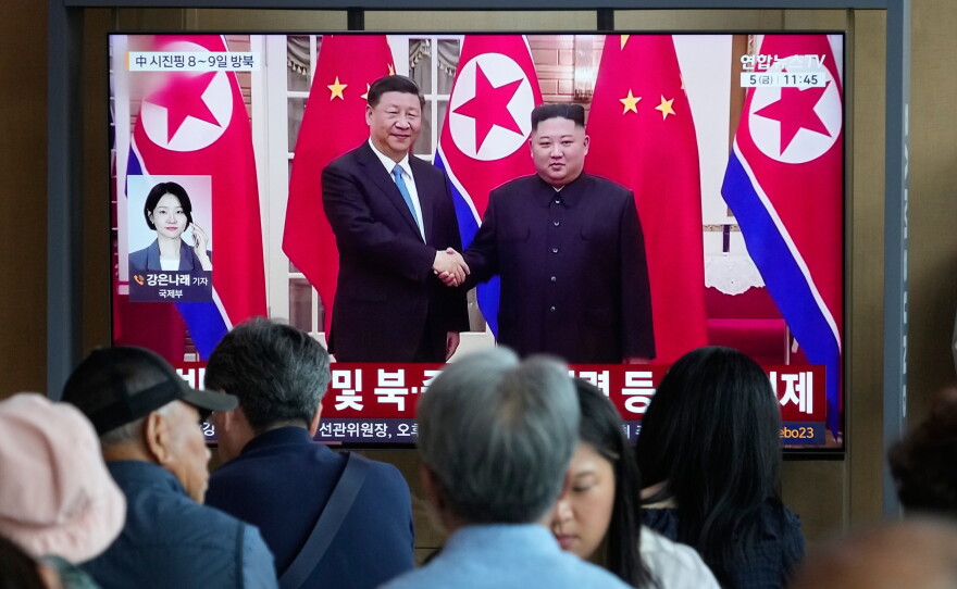 People watch a TV screen showing a file image of North Korean leader Kim Jong Un, right, and Chinese President Xi Jinping, at the Seoul Railway Station in Seoul, South Korea, Friday, June 5, 2026.
