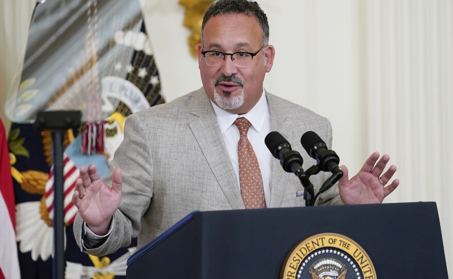 Education Secretary Miguel Cardona speaks at the White House on April 27. The Biden administration proposed a dramatic rewrite of campus sexual assault rules on Thursday, moving to expand protections for LGBTQ students, bolster the rights of victims and widen colleges' responsibilities in addressing sexual misconduct.