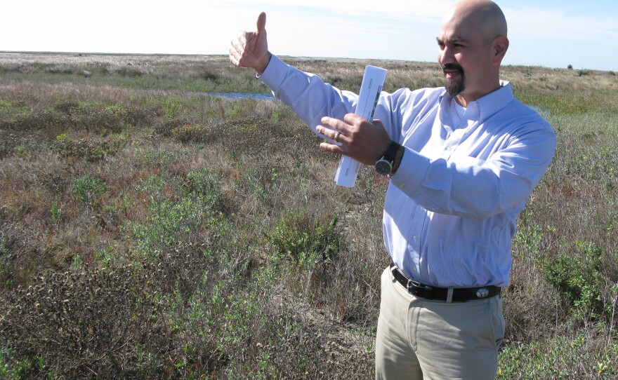 Gilbert Salinas, executive vice president of the Brownsville Economic Development Council, stands in the area where SpaceX might build its first commercial orbital launch site.