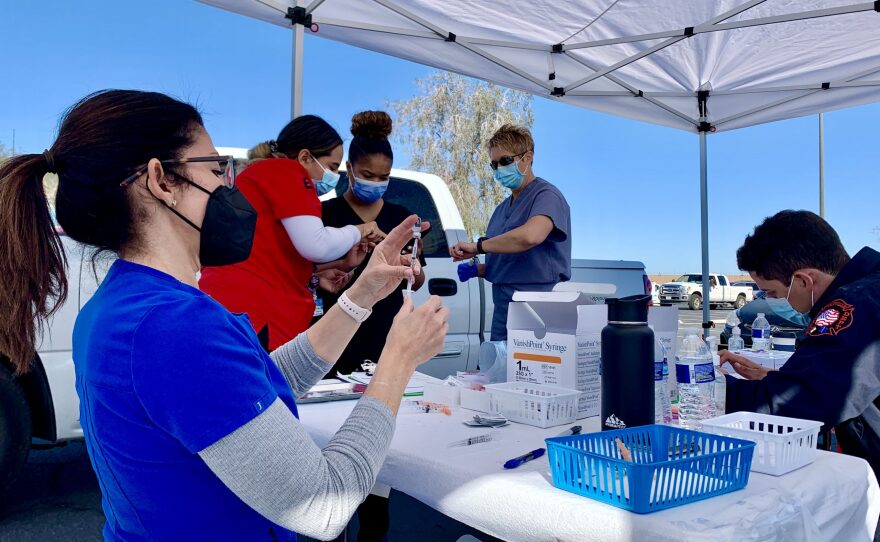 The Imperial County Public Health Department and partnering agencies prepare COVID-19 vaccine doses during a drive-through clinic for residents 65 and older on March 5, 2021.
