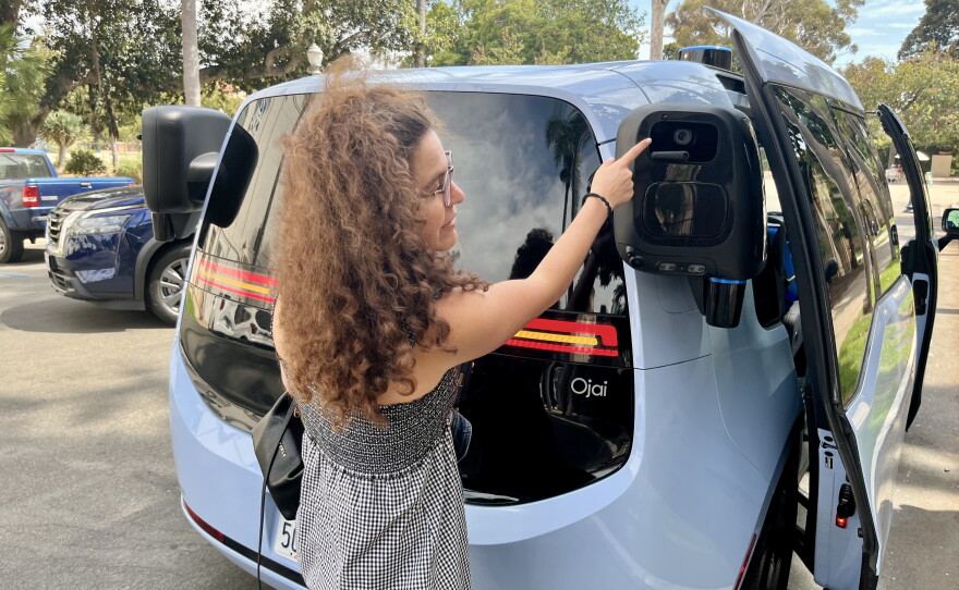 Waymo spokesperson Sandy Karp explains the sensors and cameras on the outside of their Ojai vehicles, Aug. 20, 2026.