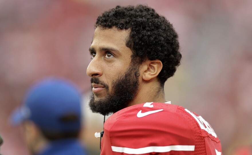 San Francisco 49ers quarterback Colin Kaepernick stands on the field during an NFL football game against the Atlanta Falcons in Santa Clara, Calif.