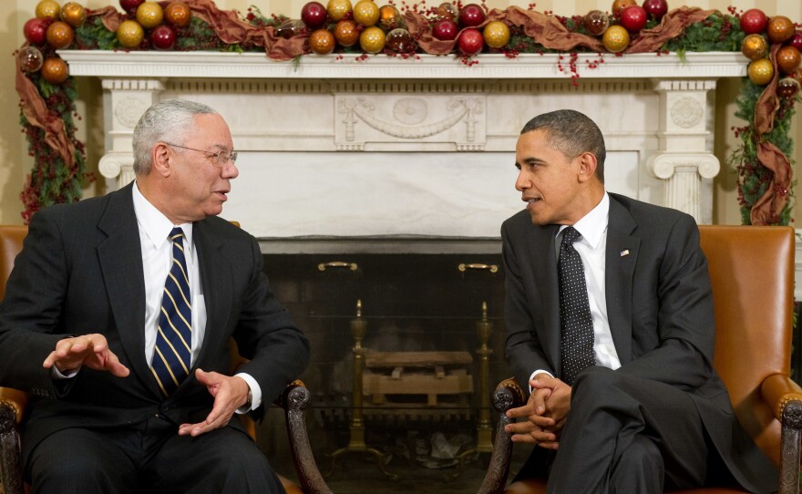 President Barack Obama speaks with former Secretary of State Colin Powell in the Oval Office on Dec. 1, 2010. Powell, who had broken his longtime Republican ties to endorse Obama in 2008, died Monday.