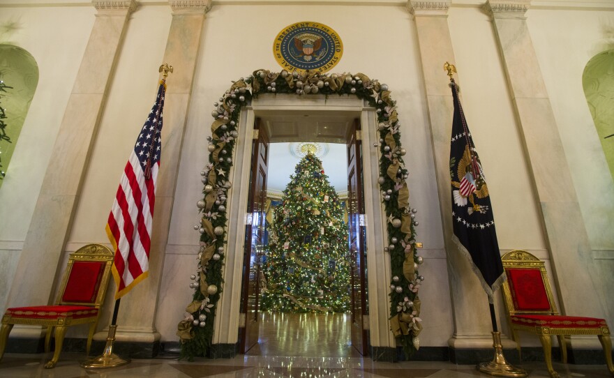 A Christmas tree stands in the Blue Room of the White House. About 65,000 people are expected to visit the White House during the holidays.