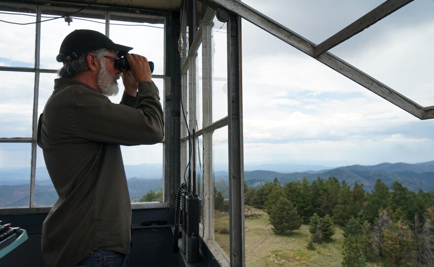 Connors looks through his binoculars. He's spent thousands of hours contemplating the contours of southwest New Mexico.
