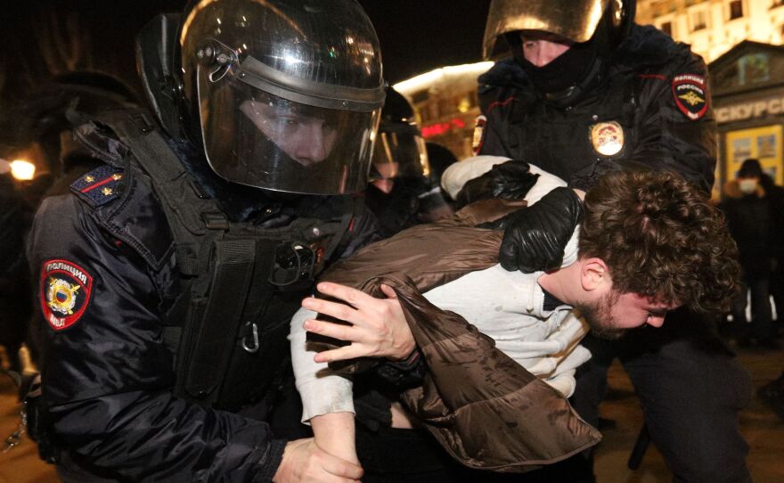 Police detain a demonstrator during a protest against Russia's invasion of Ukraine in central Saint Petersburg on February 27, 2022.