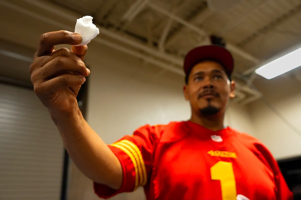 Raul Flores holds up a piece of lithium chloride at Imperial Valley Community College while explaining to his classmates how it is extracted and refined on Oct. 5, 2023.