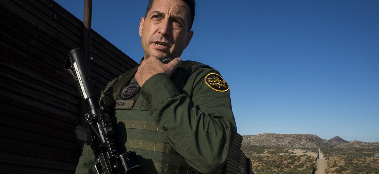 Border Patrol agent Joshua Wilson radios dispatchers to notify them of his location while touring the U.S.-Mexico border near Jacumba in eastern San Diego County on Sept. 5, 2017.