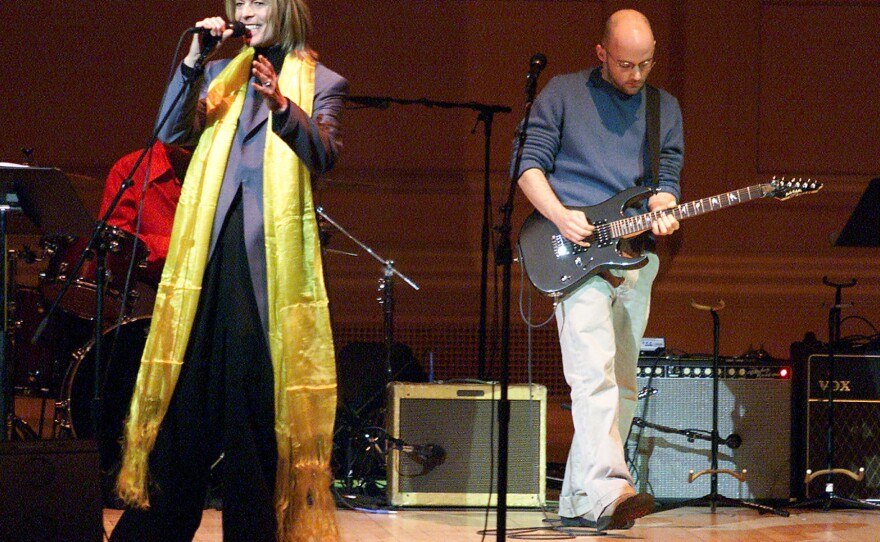 Moby (with guitar) performs with David Bowie at the Tibet House Benefit Concert in 2001.