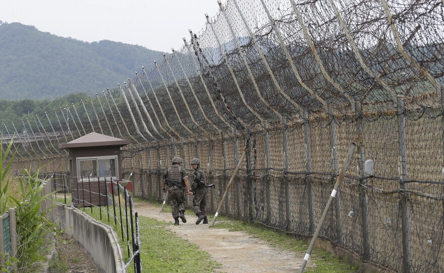 South Korean soldiers patrol while hikers visit the DMZ Peace Trail in the Demilitarized Zone in Goseong, South Korea. A defector from North Korea was apprehended in Goseong last week after evading South Korean guards for hours.