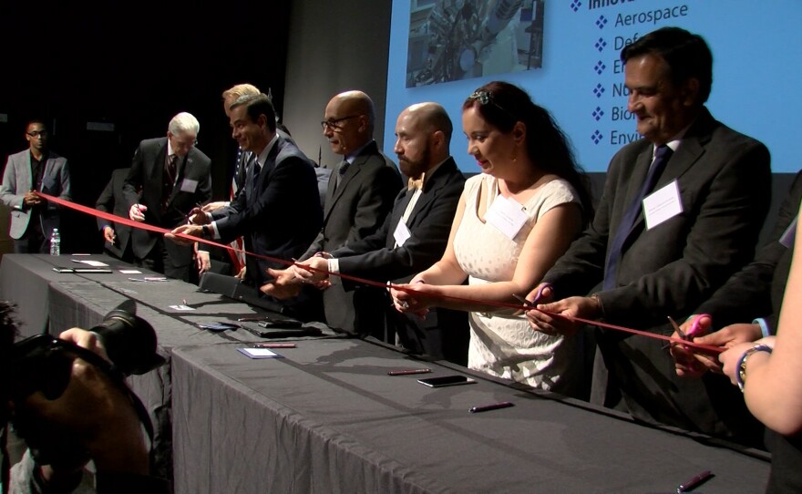 Officials cut a ceremonial ribbon at UC San Diego to celebrate a cross-border research collaboration, May 24, 2016.