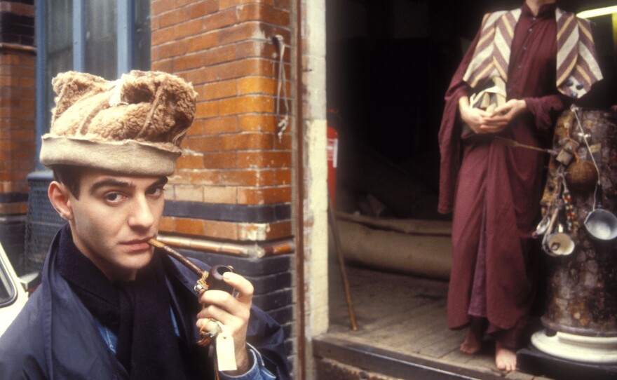 John Galliano (left) and model Jon Evans show off clothing and accessories from "Afghanistan Repudiates Western Ideals," a fashion collection that Galliano presented in July 1984 as his graduation thesis at Central Saint Martins-University of the Arts London.