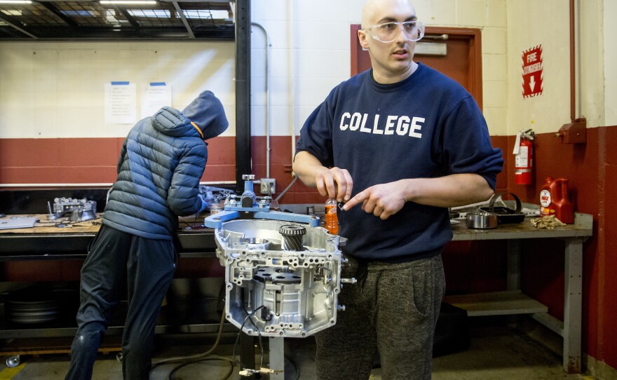 Matthew Dickinson, 21, asks a classmate for help as they rebuild an automatic transmission back in 2018 in a class at the Lake Washington Institute of Technology.