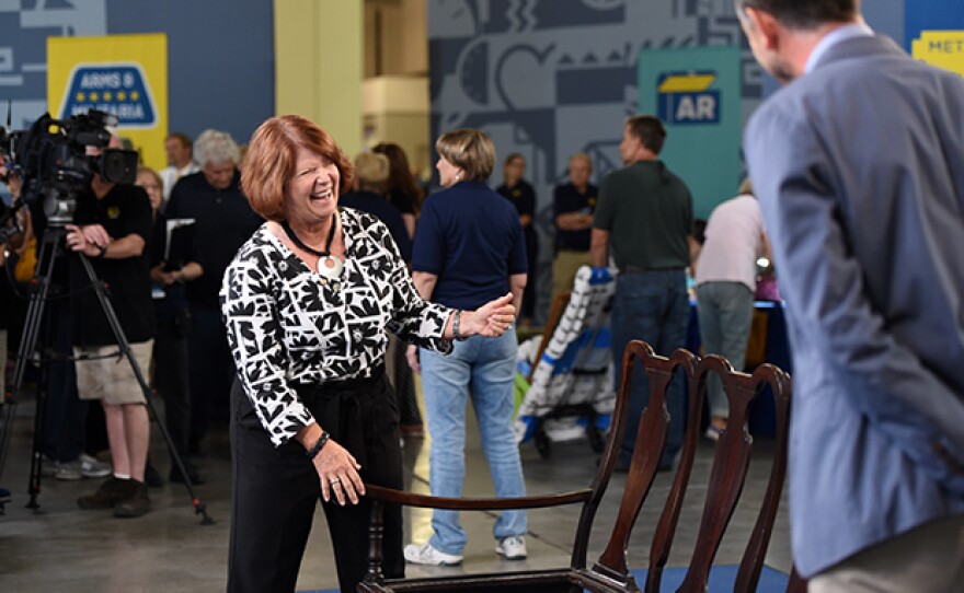 Sebastian Clarke (right) appraises a Dutch Colonial chair-back settee in Tucson, Ariz.