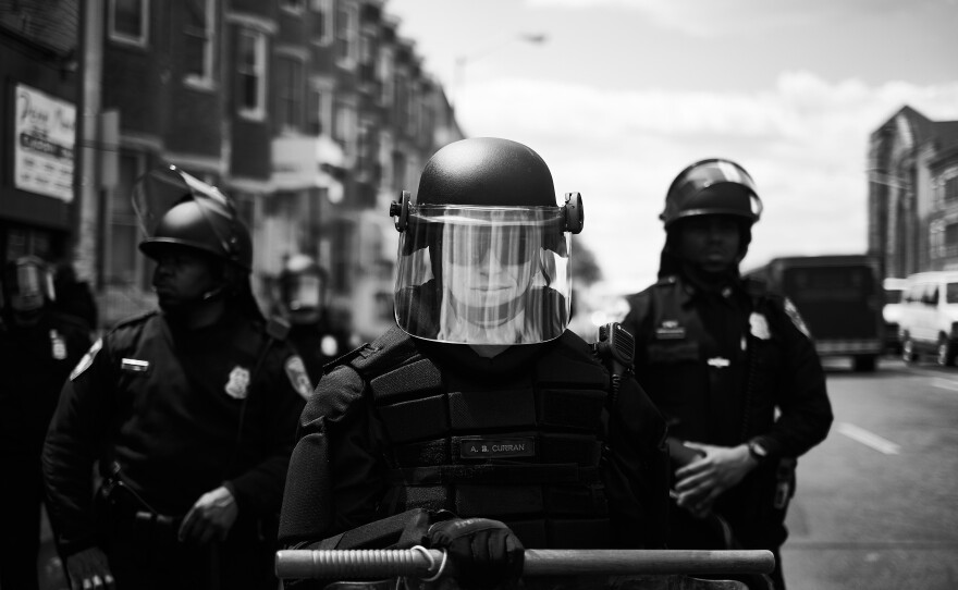 Police and National Guard officers block off Pennsylvania Avenue during protests over Freddie Gray's death in Baltimore, Md., in 2015.