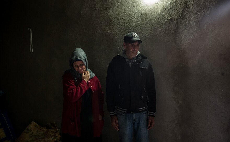 The parents of Abdelwaheb Hablani, Fouzia Araissi (left) and Jilani Hablani, stand in their home in Jelma.