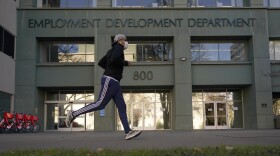 Above, a runner passes the office of California's Employment Development Department in Sacramento in December 2020.