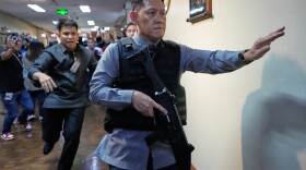 Senate security run after gunfire was heard along a hallway at the Philippine Senate in Pasay, Philippines, Wednesday.