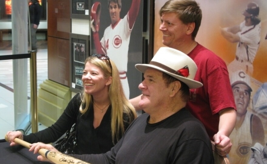 Pete Rose (front, right) poses with fans Scott and Tiffany Van Alstyne at the Art of Music memorabilia store in Las Vegas. Every week, he goes to the store to sign autographs.