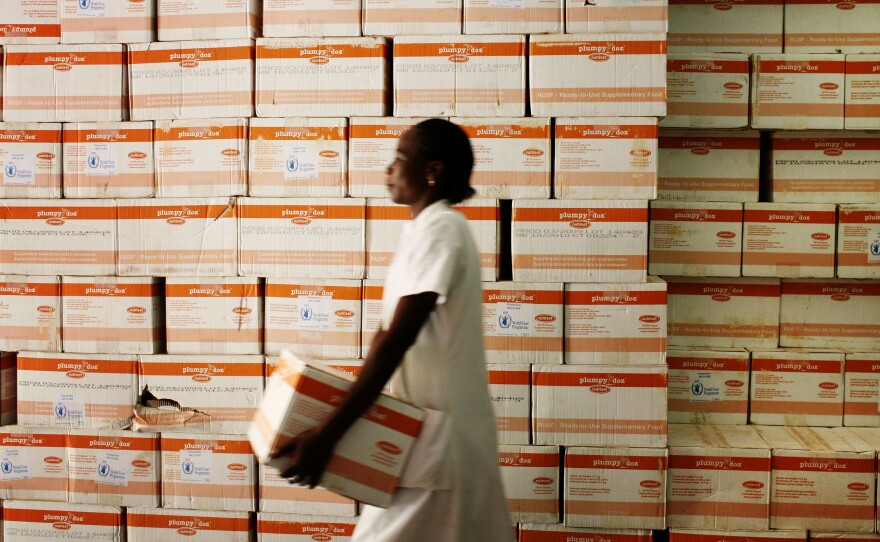 A nutritionist fetches a carton of Plumpy'Nut for malnourished patients at a hospital in Burkina Faso.