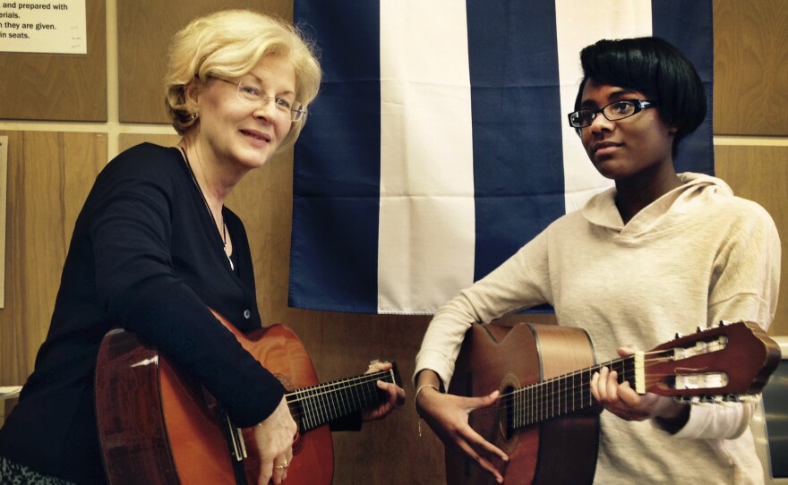 Jackie Zielke and eighth-grader Chartreanna Watson practice a guitar duet at Brady Middle School in Pepper Pike, Ohio.