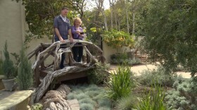 Host Nan Sterman and landscape designer Nick Dean admire the feeling of water created by the blue green grasses flowing out from under the bridge in this low-water garden design from the Hancock Park neighborhood of Los Angeles.